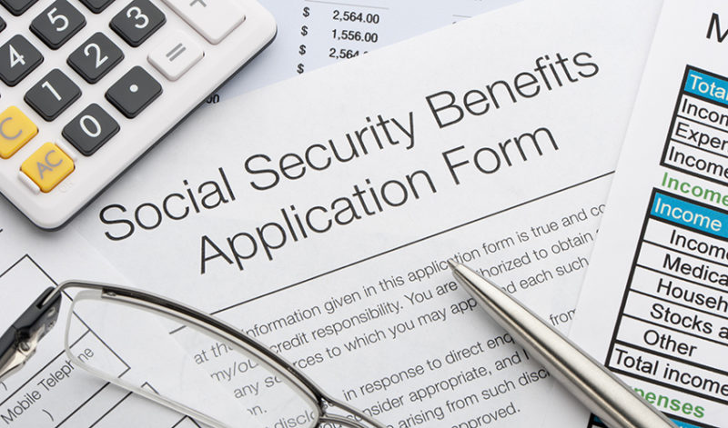 Social Security benefits application form being filled out for retirement.